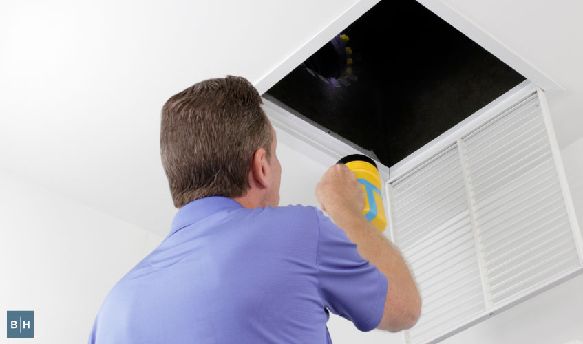 Technician inspecting AC
